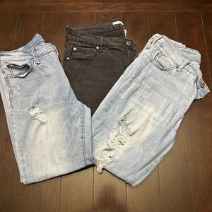 3 pairs of Celebrity Pink distressed jeans.